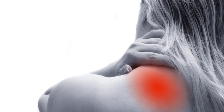 A woman against a stark white background presenting with shoulder / upper neck pain, depicted with a glowing red orb representing the pain.