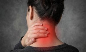A woman, seen from behind, presenting with some upper back pain, the pain is visualised with a glowing red graphic overlaid.