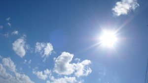 An image of a blue sky with sunlit clouds, depicting a feeling of contentment.