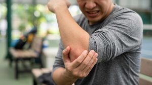 A person suffering with tennis or golfer's elbow